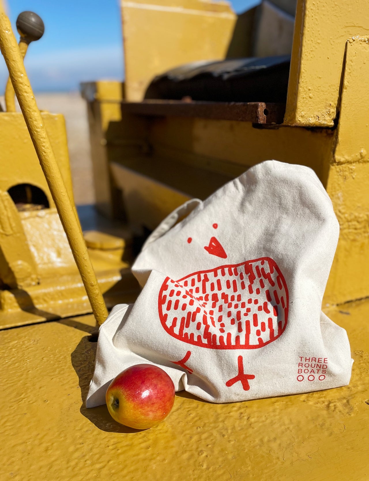 Red screen printed bird on a natural colour tote bag